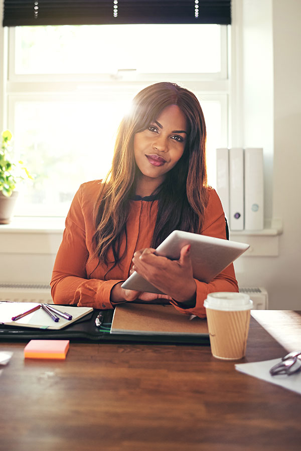 confident-young-woman-using-a-tablet-in-her-home-o-PAP4V2Y.jpg